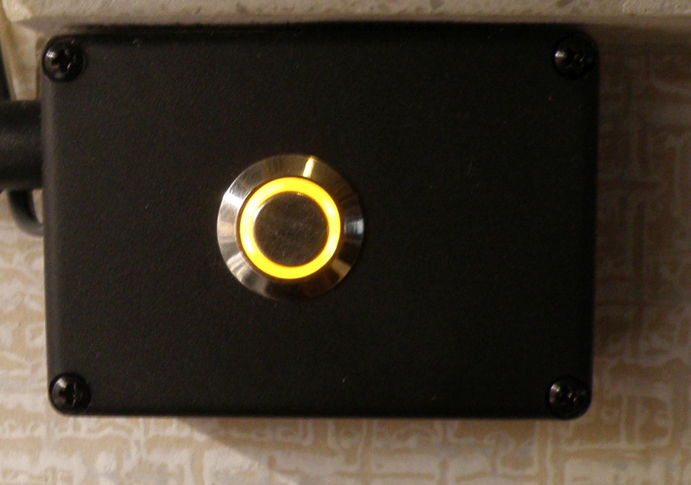 Finished enclosure front with iluminated button